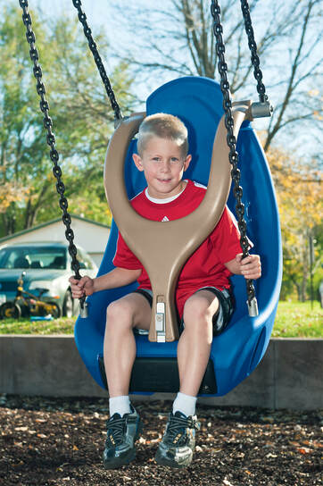 Boy in molded bucket seat with harness