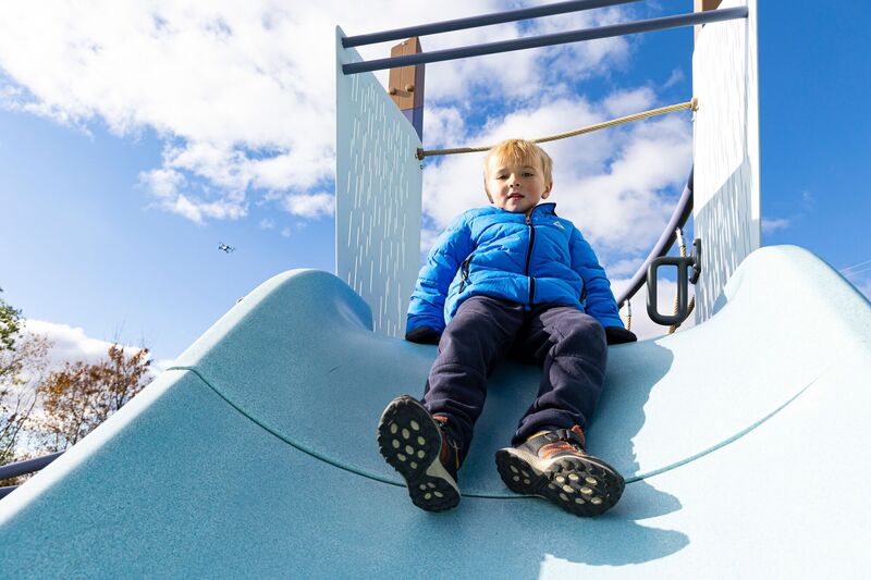 Kid sliding down the forma alpine slide